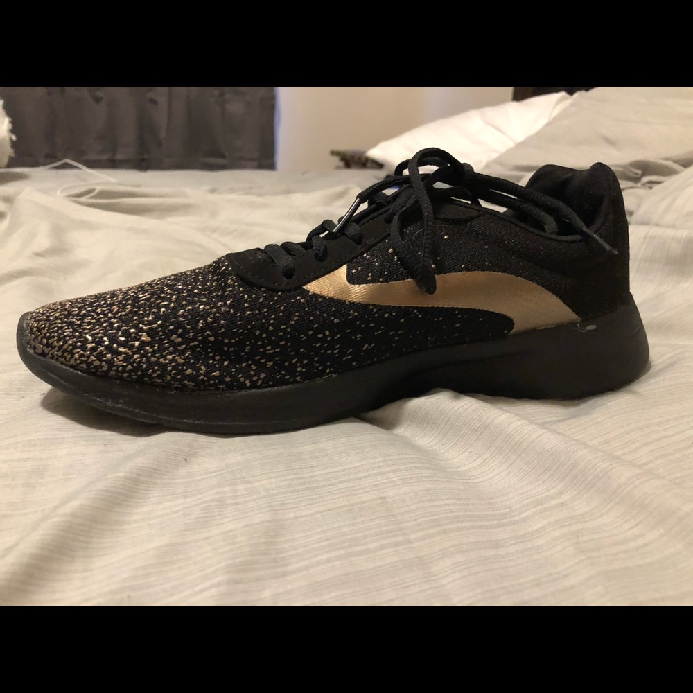 Black and gold tennis shoes